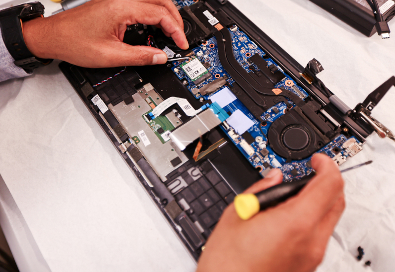 hard at work fixing a laptop