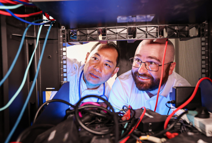 Henry and Darren checking a cabinet of wires for a local network