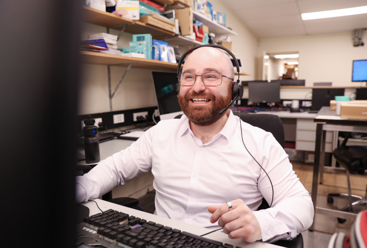 Darren reacts at screen while working on desktop